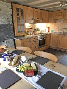 a kitchen with a table with a plate of food on it at 3 Bed in Blaenau Ffestiniog oc-wah538 in Trawsfynydd +17 photos