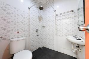 a bathroom with a toilet and a sink at Urbanview Hotel Niraz Banjarmasin by RedDoorz in Sungai Lutus +28 photos