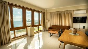 a living room with a couch and a table at Vignetta Mare 2BR Villa με Θέα & και Ιδιωτικό Πάρκινγκ in Ermoupoli