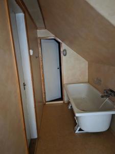 a bathroom with a large white tub and a window at Blomstermåla in Blomstermåla