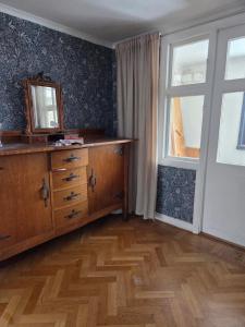 a room with a dresser and a mirror and a window at Blomstermåla in Blomstermåla