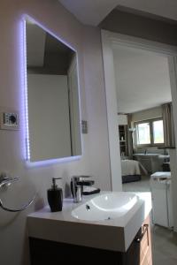 a bathroom with a white sink and a mirror at Panoramic Luxury Little Penthouse in Florence