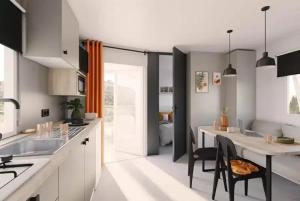 a kitchen with a table and a dining room at ZEcamping 3 étoiles vue exceptionnelle et soirées animées in Gex