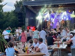 a crowd of people sitting at tables in front of a stage at Camping 3 étoiles - Piscine - ccbfa0c in Saint-Mandé-sur-Brédoire