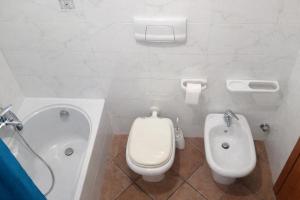 a bathroom with a toilet and a bidet at Milano in Saronno