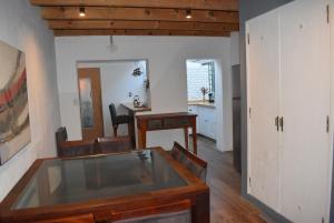 a dining room with a glass table and chairs at Cocina Bajo las Estrellas in Martínez