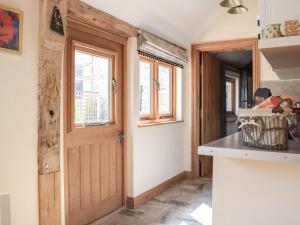 a kitchen with a wooden door and a counter at Badgers Den - Uk32084 in Dorstone +13 photos