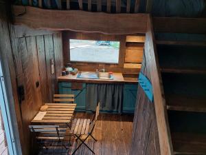 a kitchen with a sink and a table and chairs at Mirabel - DreamsCanGrow in Hasselt