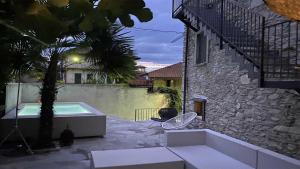 a backyard with a swimming pool and a house at Lago Lounge & Pool in Stresa