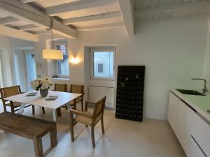 a kitchen and dining room with a table and chairs at Lago Lounge & Pool in Stresa