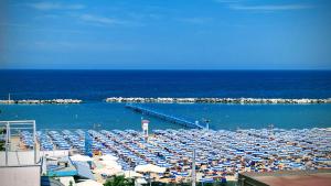 a beach filled with lots of umbrellas and the ocean at Hotel Capitol - Bianchi Hotels in Bellaria-Igea Marina