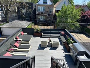 a patio with couches and chairs on a roof at The Lyons' Den in Chicago
