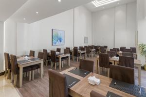 a dining room with tables and chairs in a room at بيست ليفل للشقق المخدومة in Al Khobar
