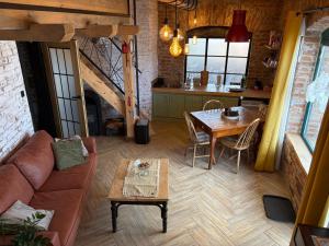 a living room with a couch and a table at Apartmán u Ondrika in Spišské Tomášovce