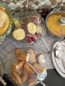 a table topped with a plate of food with fruit at Porto Pousada in Ipojuca