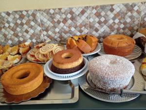 a bunch of different types of cakes and pastries at Porto Pousada in Ipojuca +2 photos