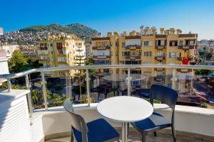 a table and chairs on a balcony with a view at Ramira Joy Hotel in Alanya