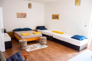 a room with two beds and a table in it at AB Holiday Home in Siófok +15 photos