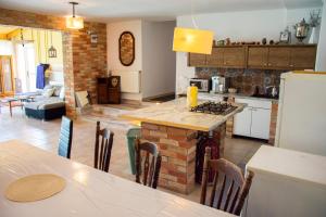 a kitchen and living room with a table and a stove at AB Holiday Home in Siófok
