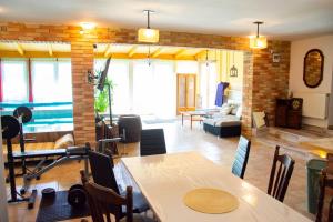 a living room with a dining table and a living room at AB Holiday Home in Siófok