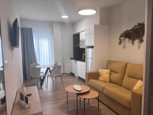 a living room with a couch and a table at Aparthotel L' Alcor in Alicante