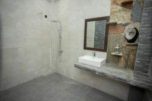 a bathroom with a sink and a mirror at Asoria Luxe Resort in Kegalle