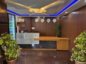 an office with a desk and clocks on the wall at Hotel Fortune 36 in Bangalore