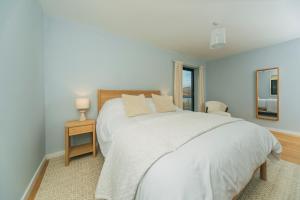 a bedroom with a white bed and a mirror at The Star House in Glendale
