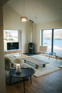 a living room with a couch and tables and a fireplace at The Star House in Glendale