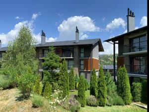 a house with trees in front of it at Apartament 5 persones Llar de Foc i Piscina in Saillagouse