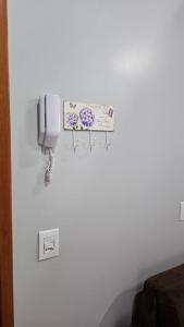 a phone on a wall in a room at loft - studio excelente localização! in São Félix do Xingu