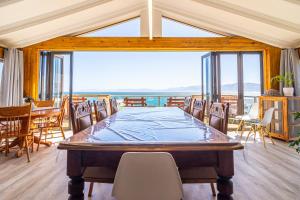 a large dining room with a table and chairs at Whale Heights in De Kelders