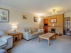 a living room with a couch and a fireplace at 2 Bed in Killin oc-pe512 in Killin