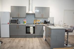 a kitchen with stainless steel appliances and a counter at Flat 2 Aylesbury Street in Bletchley +11 photos