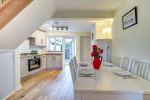 a kitchen with a table with a vase of flowers on it at 3 Bed in Bridport oc-wy401 in Bridport