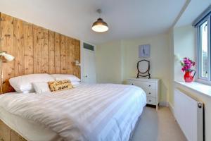 a bedroom with a large bed with a wooden headboard at 3 Bed in Bridport oc-wy401 in Bridport