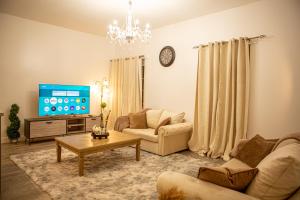 a living room with a couch and a tv at Flat 2 Aylesbury Street in Bletchley