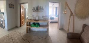a living room with a table with a boat on it at Sea La Mer Villa in Wilderness