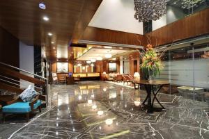 a lobby of a hotel with a table and chairs at Lavender Premier in Bangalore