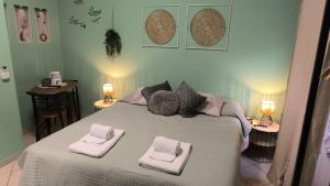 a bedroom with a large bed with towels on it at Casa Giulia Affittacamere FORUM ASSAGO M2 M1 Milano CENTRO in Corsico +14 photos