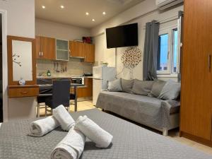 a living room with a couch and a kitchen at Angeligue Studio with Balcony in Ipsos