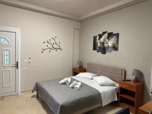 a bedroom with a bed with two stuffed animals on it at Angeligue Studio with Balcony in Ipsos