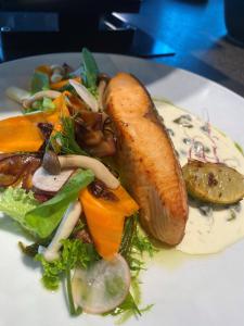 a plate of food with a hot dog and vegetables at Four Points by Sheraton Budapest Danube in Budapest