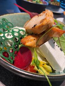 a plate of food with meat and vegetables on a table at Four Points by Sheraton Budapest Danube in Budapest