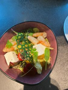 a plate of food with vegetables on a table at Four Points by Sheraton Budapest Danube in Budapest