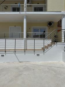 a building with a balcony with a person standing on it at K&L Luxury Suite 2 in Parga