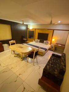 a bedroom with a bed and a table and a keyboard at Hotel Rahul Deluxe in Nagpur