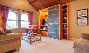 a living room with a couch and a table at Underscar - Luxury 2 Bed Apartment in Keswick