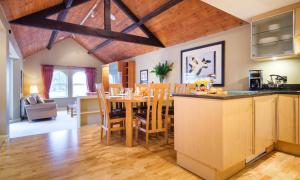 a kitchen and dining room with a table and chairs at Underscar - Luxury 2 Bed Apartment in Keswick