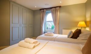 a bedroom with two beds and a window at Underscar - Luxury 2 Bed Apartment in Keswick +31 photos